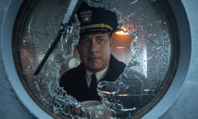 Tom Hanks looks through broken glass.