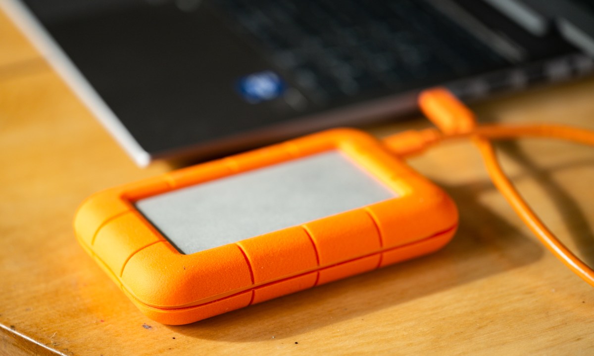 LaCie external hard drive next to a laptop computer.