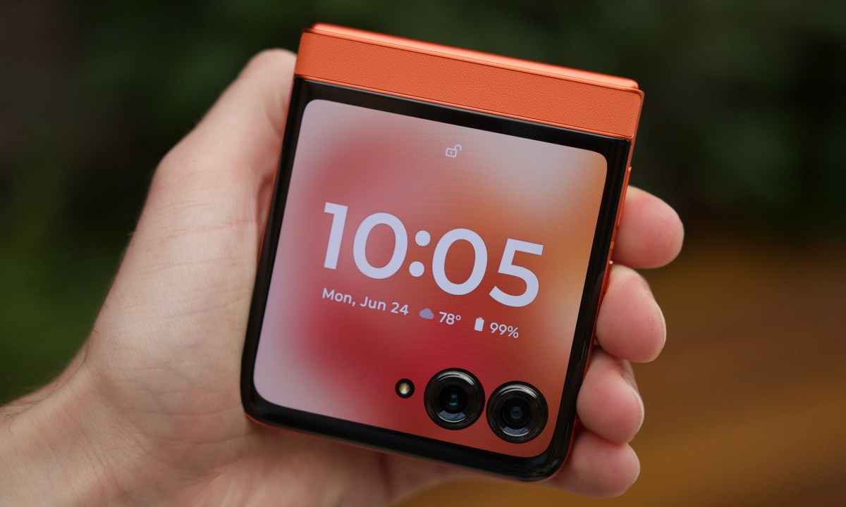 Someone holding the Motorola Razr 2024, showing its cover screen.