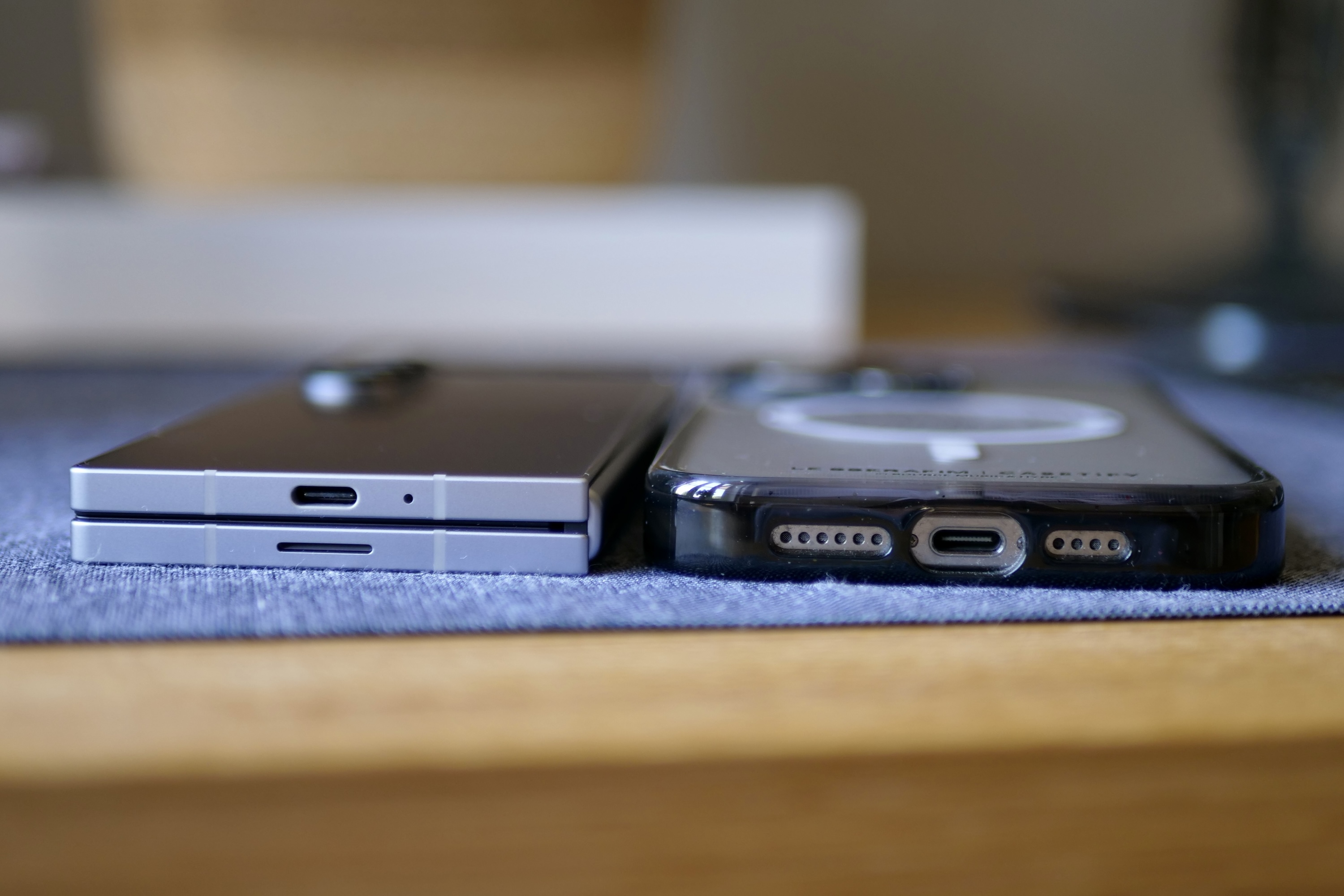 The Samsung Galaxy Z Fold 6 and the Apple iPhone 15 Pro Max, showing the difference in thickness.