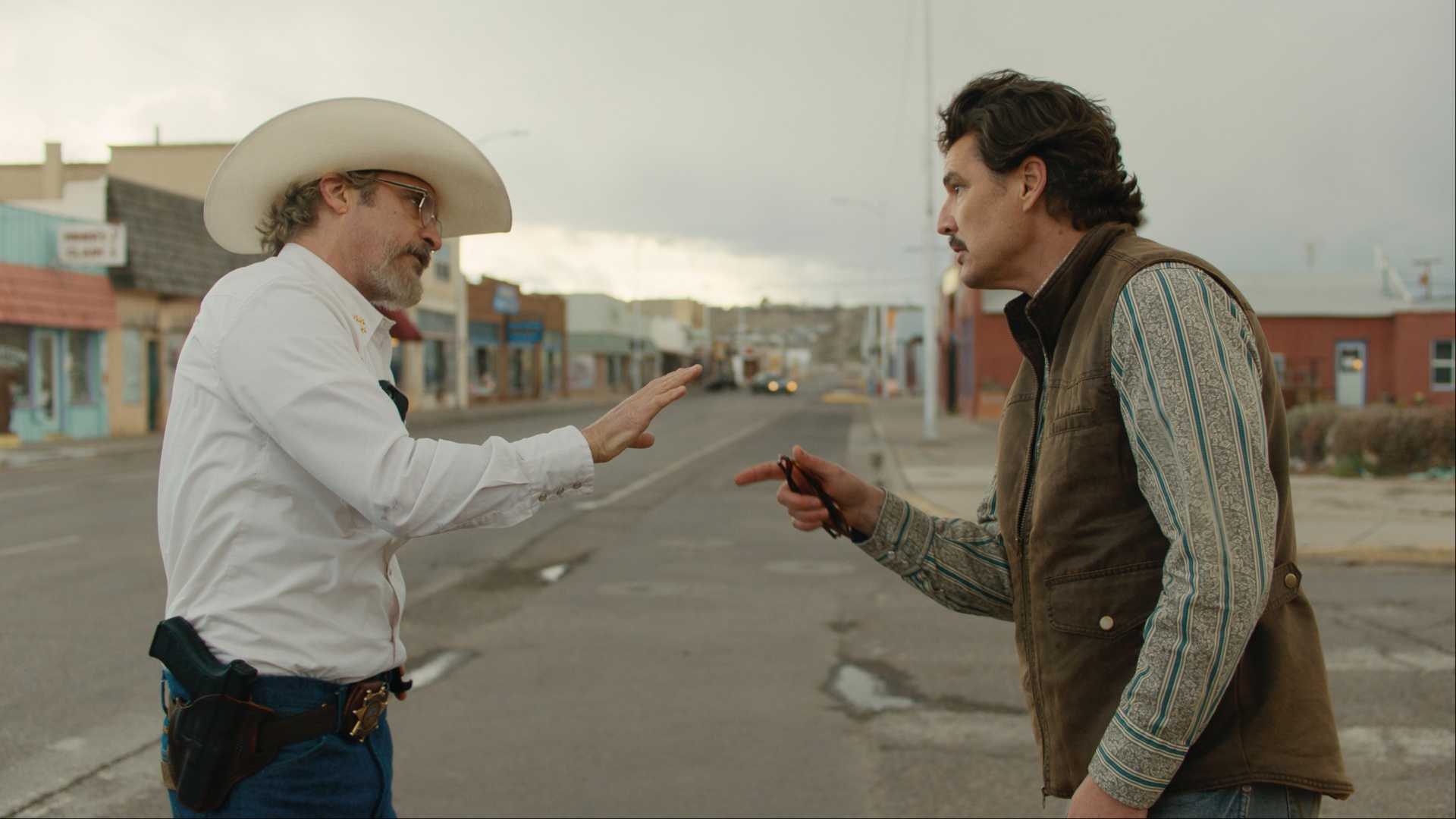Pedro Pascal points at Joaquin Phoenix.