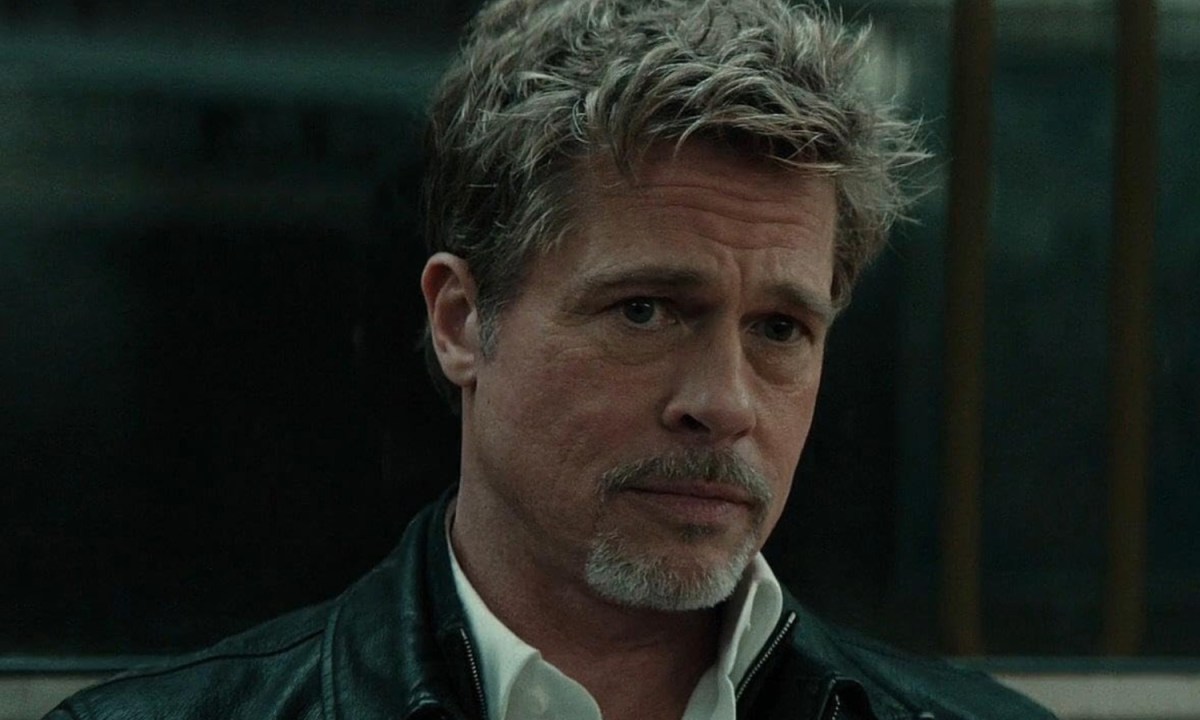 Bradd Pitt sits down and looks.